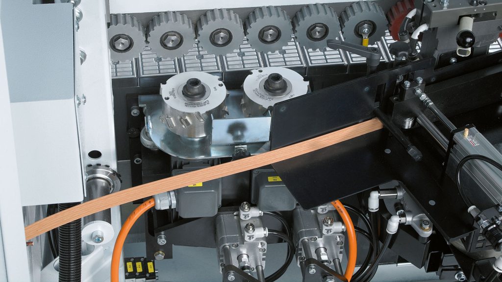 HOMAG joint-trimming unit preparing the straight edge of a furniture panel